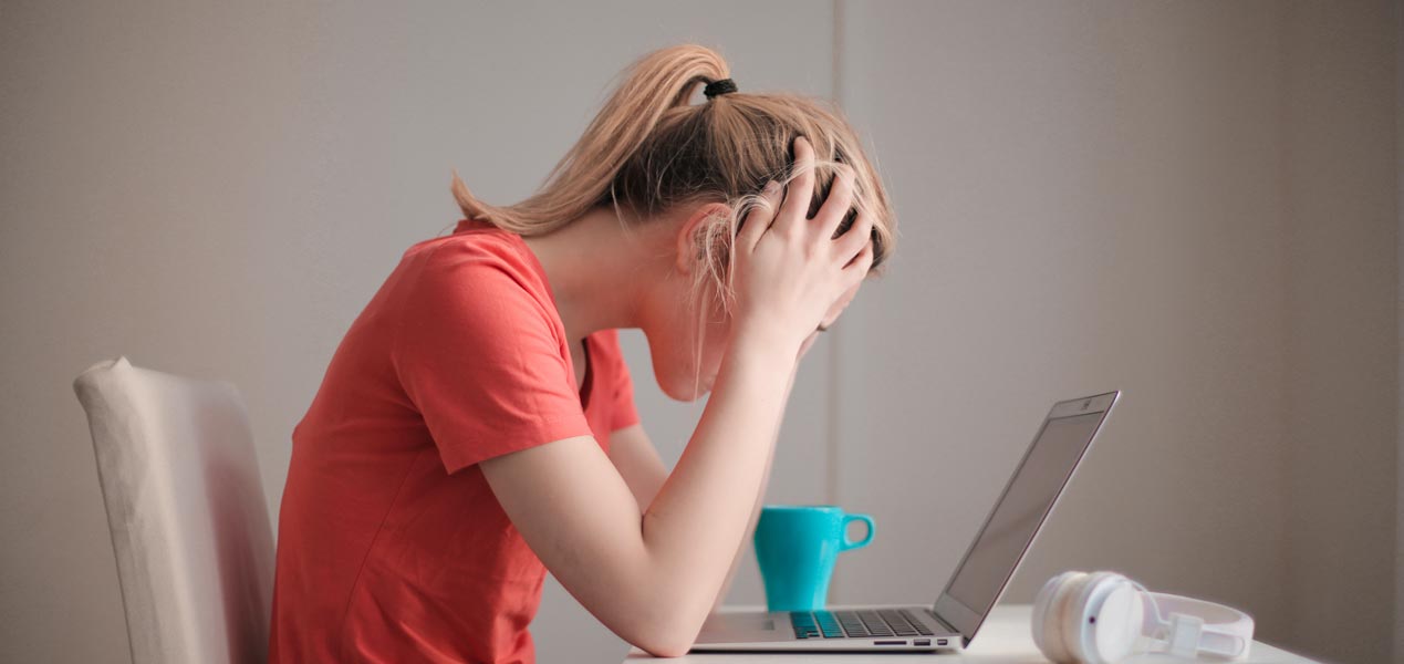 Woman stressed working with laptop